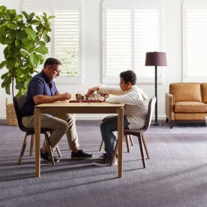 Family playing chess On Carpet | Nemeth Family Interiors
