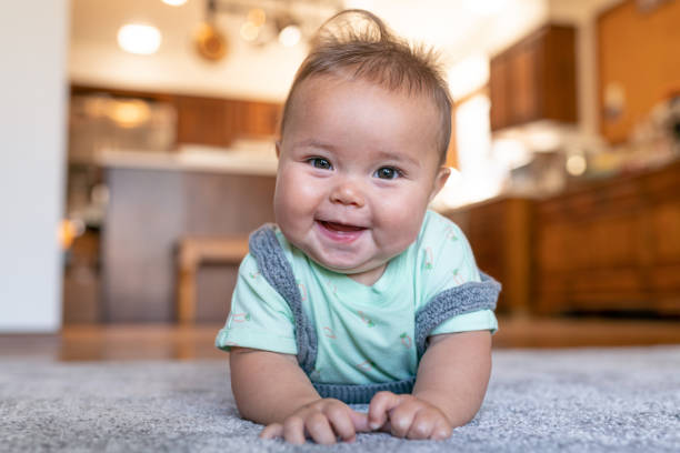 Cute baby on rug | Nemeth Family Interiors